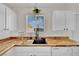 This kitchen features butcher block countertops, a black sink, and white cabinets at , Las Vegas, NV 89139