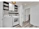 Functional laundry room featuring modern white appliances, storage cabinets, and stylish wall decor at , Las Vegas, NV 89139