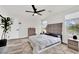 Cozy main bedroom with a gray upholstered headboard, modern furnishings, and wood-look floors at , Las Vegas, NV 89139