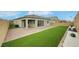 Expansive backyard featuring brick pavers, artificial grass, and easy to care landscaping at 10161 Ocher Valley Ave, Las Vegas, NV 89178