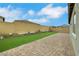 Backyard featuring brick pavers, artificial grass, and low maintenance landscaping at 10161 Ocher Valley Ave, Las Vegas, NV 89178