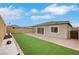 Backyard features a patio, artificial grass, and easy to care landscaping at 10161 Ocher Valley Ave, Las Vegas, NV 89178