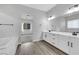 Modern bathroom with double sinks, quartz countertop, and a soaking tub at 10161 Ocher Valley Ave, Las Vegas, NV 89178