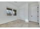 Bright bedroom features carpet floors, white walls, and sliding closet doors at 10161 Ocher Valley Ave, Las Vegas, NV 89178