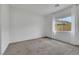Neutral bedroom with soft carpet, neutral walls, and backyard view at 10161 Ocher Valley Ave, Las Vegas, NV 89178
