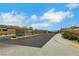 Community entrance with landscaped median, iron gates, and decorative signage at 10161 Ocher Valley Ave, Las Vegas, NV 89178