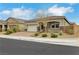 Charming single-story home with a two-car garage, desert landscaping, and a brick-paved driveway at 10161 Ocher Valley Ave, Las Vegas, NV 89178
