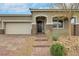 Inviting front entrance with stone pillars, brick-paved pathway, and well-maintained landscaping at 10161 Ocher Valley Ave, Las Vegas, NV 89178