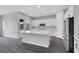 This bright kitchen boasts stainless steel appliances, a kitchen island, and neutral flooring at 10161 Ocher Valley Ave, Las Vegas, NV 89178