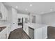 Bright, modern kitchen featuring white cabinets, stainless steel appliances, and a large center island at 10161 Ocher Valley Ave, Las Vegas, NV 89178