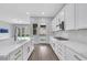 Modern kitchen with stainless steel appliances, quartz countertops, and backyard access at 10161 Ocher Valley Ave, Las Vegas, NV 89178