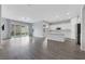 Open-concept living room with hardwood floors, recessed lighting, and sliding doors to the backyard at 10161 Ocher Valley Ave, Las Vegas, NV 89178