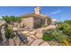 Backyard with desert landscaping, stone walkway, and lush plants in decorative pots at 10537 Shoalhaven Dr, Las Vegas, NV 89134