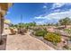 Well manicured backyard with desert landscaping and an outdoor seating area with a fire pit at 10537 Shoalhaven Dr, Las Vegas, NV 89134