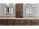 Bathroom featuring a double sink vanity, granite counters, mirrors and cabinets at 10537 Shoalhaven Dr, Las Vegas, NV 89134