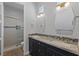 Modern bathroom featuring a double vanity, designer mirrors, and glass enclosed shower at 10537 Shoalhaven Dr, Las Vegas, NV 89134