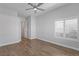 Spacious bedroom boasts wood floors, a ceiling fan, and shuttered windows at 10537 Shoalhaven Dr, Las Vegas, NV 89134