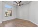 Bright bedroom featuring wood floors, neutral walls, modern ceiling fan and window with shutters at 10537 Shoalhaven Dr, Las Vegas, NV 89134