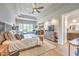 Open-concept bedroom with fireplace, hardwood floors, access to bath, and tray ceiling at 10537 Shoalhaven Dr, Las Vegas, NV 89134