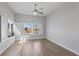 Light-filled bedroom boasts wood floors, ceiling fan, and plantation-shuttered windows at 10537 Shoalhaven Dr, Las Vegas, NV 89134