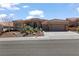 Inviting home with a terracotta roof, desert landscaping, and a three-car garage at 10537 Shoalhaven Dr, Las Vegas, NV 89134