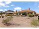 Rear exterior view showcasing the covered patio, desert landscaping, and mountain views at 10537 Shoalhaven Dr, Las Vegas, NV 89134