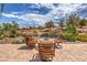 The fire pit is surrounded by four comfortable chairs and beautiful desert landscaping at 10537 Shoalhaven Dr, Las Vegas, NV 89134