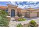 Charming home featuring a blue double-door entry, terracotta-colored roof, and mature landscaping at 10537 Shoalhaven Dr, Las Vegas, NV 89134