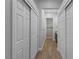 Hallway view with closet doors leading to a modern bathroom with a glass shower at 10537 Shoalhaven Dr, Las Vegas, NV 89134