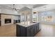 Bright and spacious kitchen features an island, stone fireplace, and stainless steel appliances at 10537 Shoalhaven Dr, Las Vegas, NV 89134