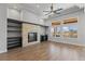 Open concept living room with stone fireplace, built-in shelves, and lots of natural light at 10537 Shoalhaven Dr, Las Vegas, NV 89134