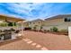 Well-maintained backyard with a covered patio, seating, BBQ, and ample space at 10657 Medicine Bow St, Las Vegas, NV 89183