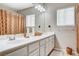 Bathroom featuring double sink vanity with large mirror at 10657 Medicine Bow St, Las Vegas, NV 89183