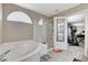 Bathroom featuring a soaking tub, glass enclosed shower and door to another room at 10657 Medicine Bow St, Las Vegas, NV 89183