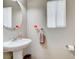 This bathroom features a pedestal sink, and a window with blinds for natural light at 10657 Medicine Bow St, Las Vegas, NV 89183