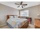 Bedroom with ceiling fan, window, and wood furnishings at 10657 Medicine Bow St, Las Vegas, NV 89183
