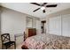 Bedroom with ceiling fan, patterned bedding, wood dresser, and access to closet at 10657 Medicine Bow St, Las Vegas, NV 89183