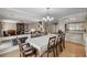 Bright dining room with a long table, chandelier, and easy access to the living area at 10657 Medicine Bow St, Las Vegas, NV 89183