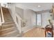 Bright entryway features wood floors, staircase, and a front door with a window and blinds at 10657 Medicine Bow St, Las Vegas, NV 89183