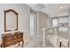 Upstairs hallway with glass railing and hardwood dresser offers clear views and ample space at 10657 Medicine Bow St, Las Vegas, NV 89183
