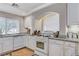 Bright kitchen features white cabinets, granite countertops, and gas range at 10657 Medicine Bow St, Las Vegas, NV 89183