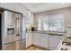 Bright kitchen features white cabinets, stainless steel refrigerator, and granite countertops at 10657 Medicine Bow St, Las Vegas, NV 89183