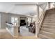 Cozy living room with plush seating, staircase, and lots of natural light at 10657 Medicine Bow St, Las Vegas, NV 89183