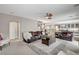 Spacious living room features comfortable seating, a ceiling fan, and easy access to the kitchen at 10657 Medicine Bow St, Las Vegas, NV 89183