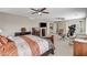 Spacious main bedroom features a bed, ceiling fans, treadmill, and plenty of natural light at 10657 Medicine Bow St, Las Vegas, NV 89183