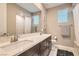 Modern bathroom featuring dual sinks, a large mirror, and bright, natural light at 10936 White Alder Pl, Las Vegas, NV 89138