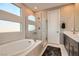 Modern bathroom featuring a soaking tub, glass-enclosed shower, tile, and neutral paint at 10936 White Alder Pl, Las Vegas, NV 89138