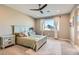 Bright bedroom with a ceiling fan, neutral walls, carpet floors, and a view of the mountains at 10936 White Alder Pl, Las Vegas, NV 89138