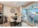 Cozy dining area with a modern table set, sliding glass door to the outdoor patio, and stylish decor at 10936 White Alder Pl, Las Vegas, NV 89138