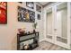 Hallway displaying sports memorabilia with a view of a room through glass paneled double doors at 10936 White Alder Pl, Las Vegas, NV 89138